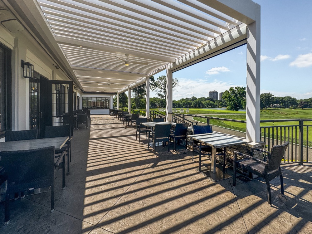 Country club with louvered roof over event space