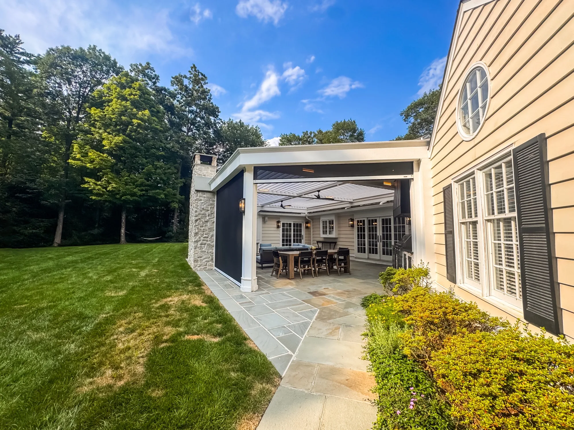 Hambrook outdoor room attached to house showing architectural integration with existing roofline