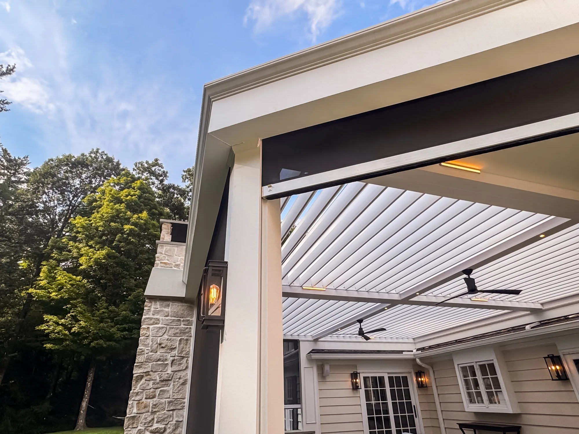 Detail of crown moulding, infrared heater panel, and louvered roof intersection