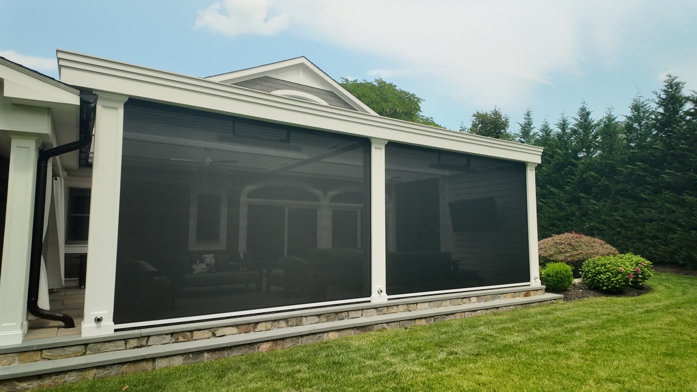 Louvered pergola with motorized screens lowered in Manhasset, NY