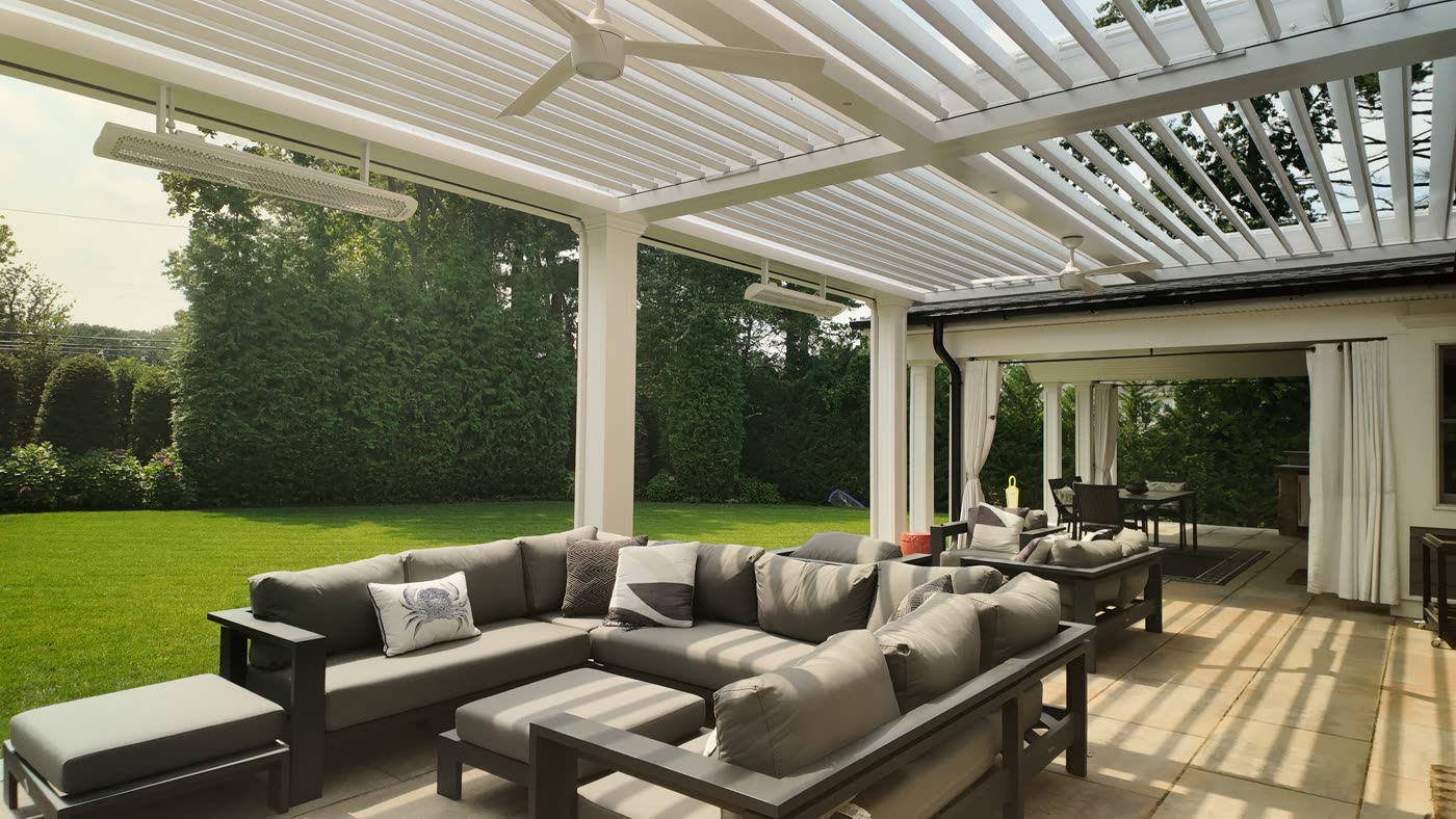Lounge under a transitional motorized pergola in Manhasset, NY